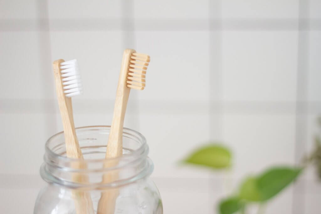 two toothbrush in mason jar